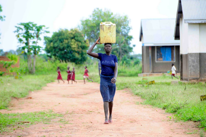 Drop in the Bucket Africa water charity-Uganda Girl walking for water Gender Equality