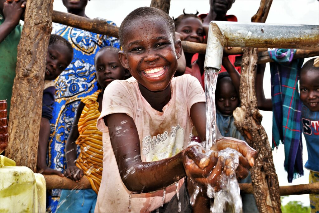 Girl getting clean water from a well drilled by Drop in the Bucket in Iganga, Uganda.